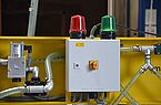 Detail picture of the red and green optical warning lights of a heavy duty vacuum lifter
