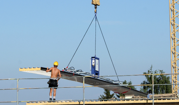 Mann benutzt Vakuumheber CLAD-MAN auf dem Dach