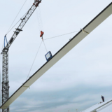 CLAD-MAN vacuum lifter attached to construction crane