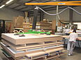 Man operates vacuum lifter of the company AERO-LIFT in the wood industry for lifting wooden boards in the workshop