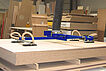 Vacuum lifter tube lifter transports 4-fold wooden plate in a production facility
