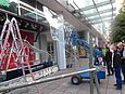 Man operating mobile vacuum lifting device CLAD-LIFT 600 while inserting a glass pane in the outdoor area