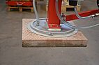 Mains independent battery operated vacuum lifter transports a board in a workshop