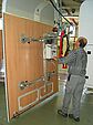 Man operates vacuum lifter of the company AERO-LIFT for transporting mobile home parts