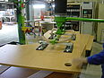 Man operates vacuum lifter of the company AERO-LIFT in the wood industry for lifting wooden boards in the workshop