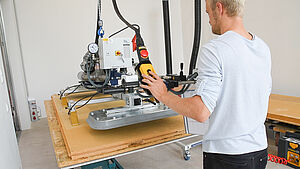 Man operates vacuum lifting device