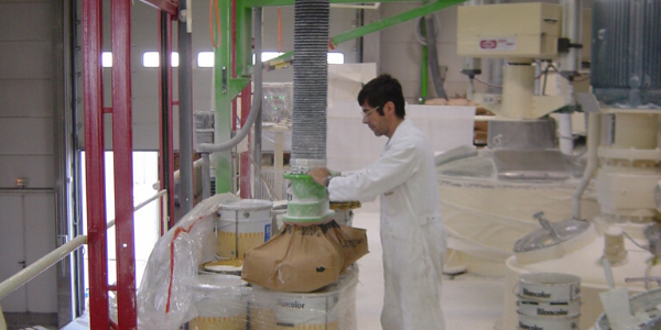 Man transports bags with tube lifter in hazardous area clean room