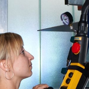 Woman looks at display of vacuum meter
